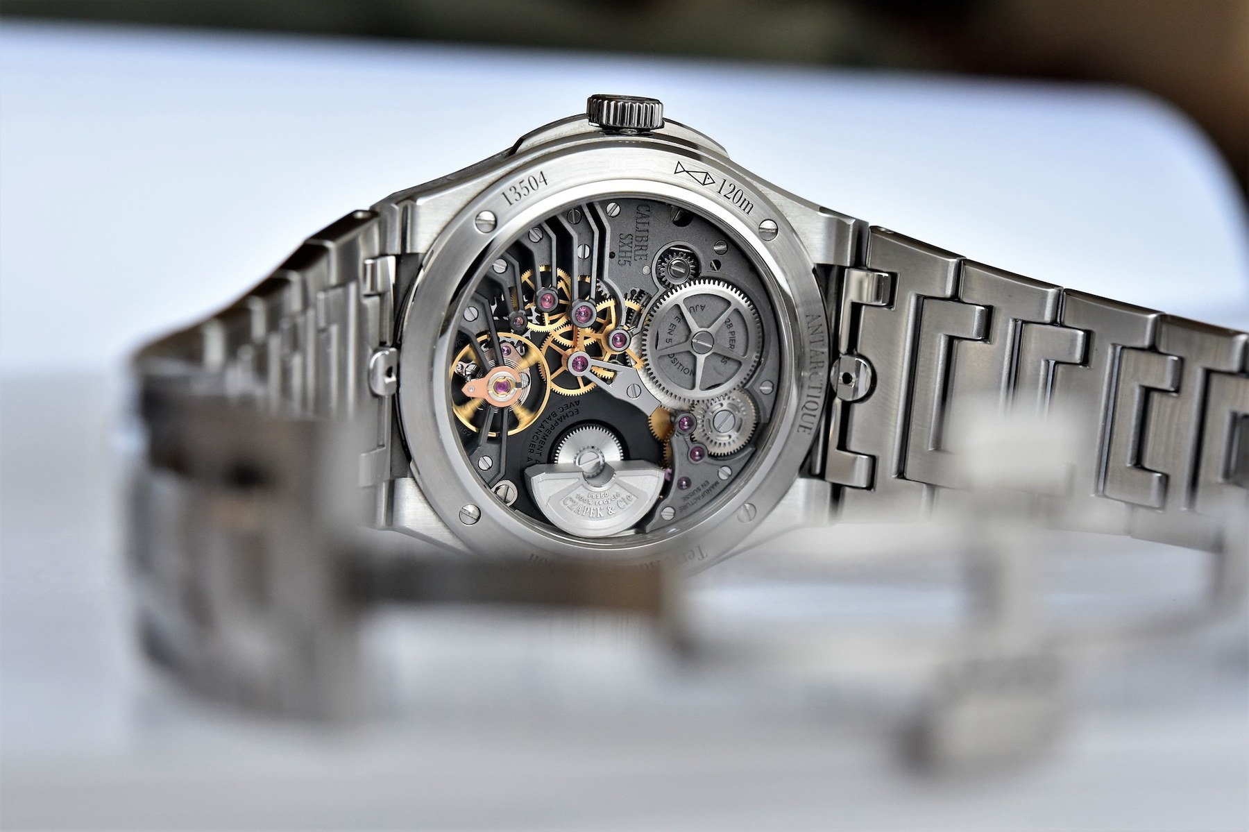 Caseback of the Czapek Antarctique Passage de Drake ref. 1532-12-RT-P-S showing the SXH5 caliber with platinum micro-rotor, hand-bevelled bridges and polished countersinks visible through the sapphire back.