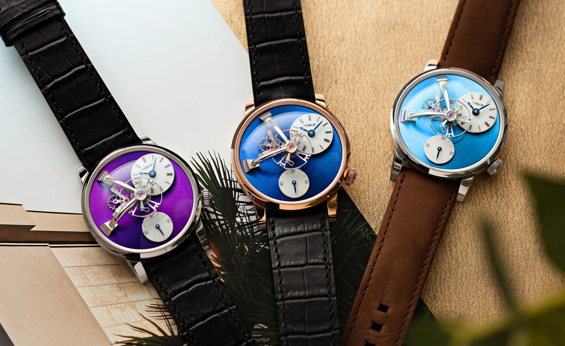 Three MB&F Legacy Machine 101 watches in violet, navy, and turquoise dials.